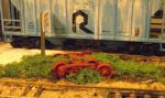 Railroad junk covered in weeds